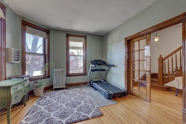 workout room with radiator heating unit and wood-type flooring