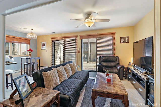 living room featuring a baseboard heating unit, light colored carpet, and ceiling fan