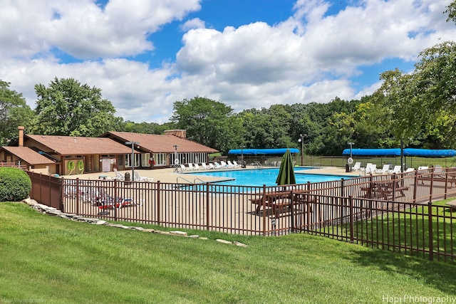 view of swimming pool with a patio area and a lawn