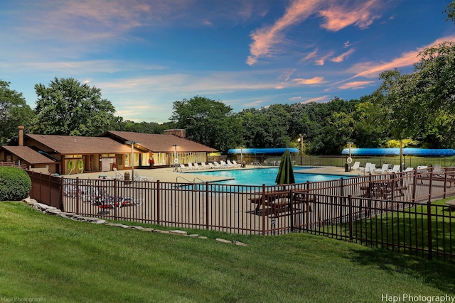 view of pool featuring a lawn and a patio