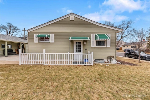 view of front of house with a front yard and a patio area