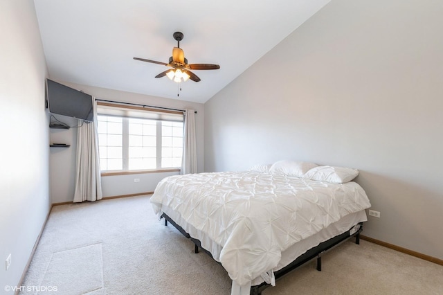 carpeted bedroom with ceiling fan and vaulted ceiling