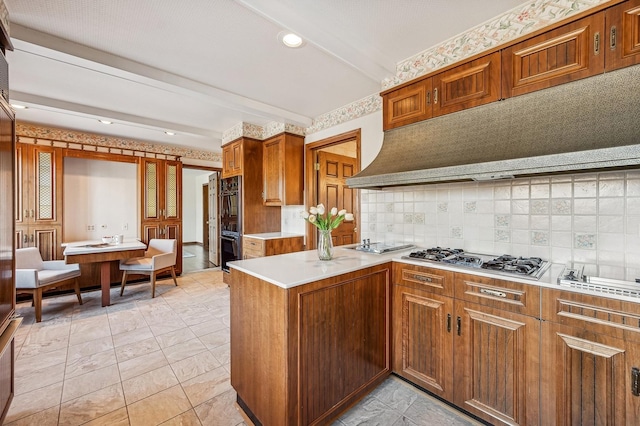 kitchen with double oven, beam ceiling, stainless steel gas cooktop, decorative backsplash, and kitchen peninsula