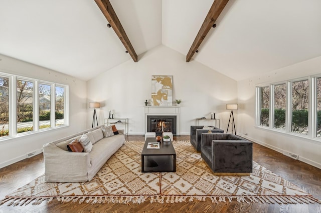 living room featuring lofted ceiling with beams, plenty of natural light, and parquet floors