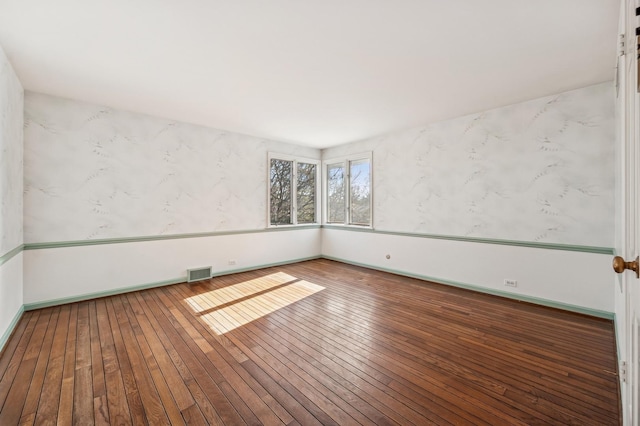 empty room with hardwood / wood-style flooring