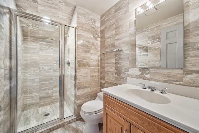 bathroom featuring vanity, tile walls, walk in shower, and toilet