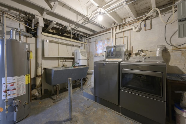 laundry area with independent washer and dryer, sink, and water heater