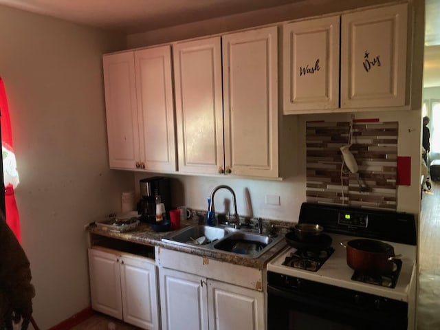 kitchen featuring white cabinetry, gas stove, sink, and tasteful backsplash