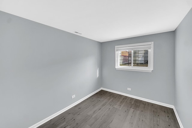 empty room with hardwood / wood-style floors