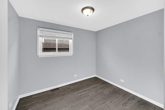 unfurnished room with dark hardwood / wood-style flooring