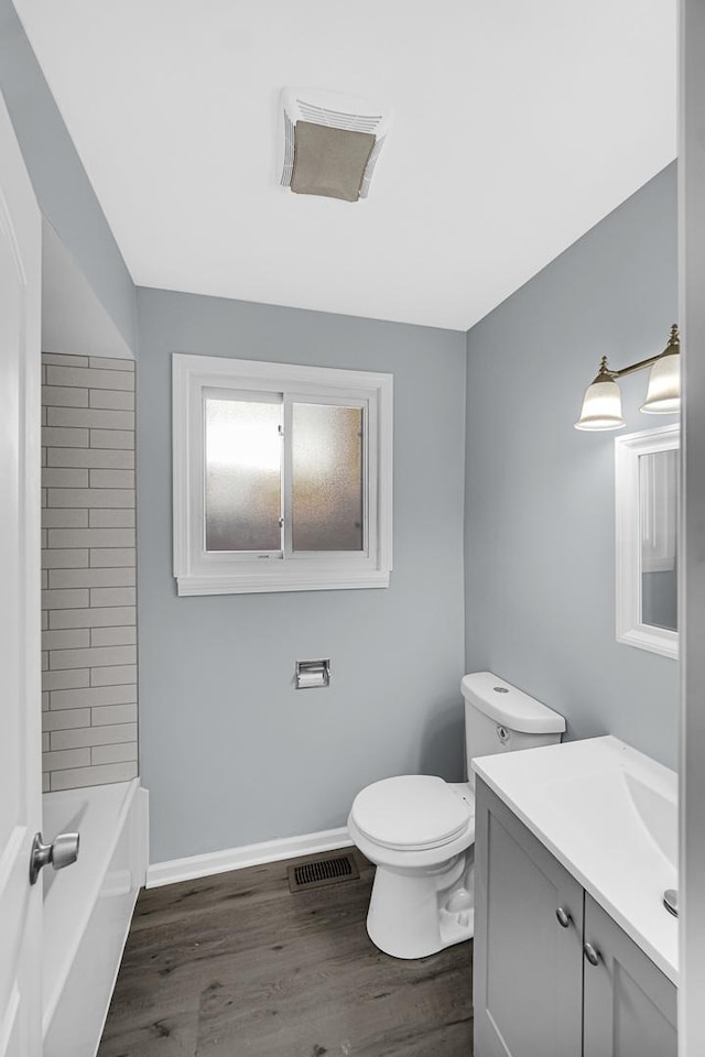 bathroom featuring vanity, hardwood / wood-style flooring, and toilet