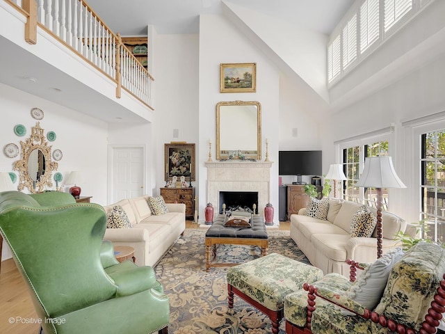 living room featuring wood-type flooring and a high ceiling