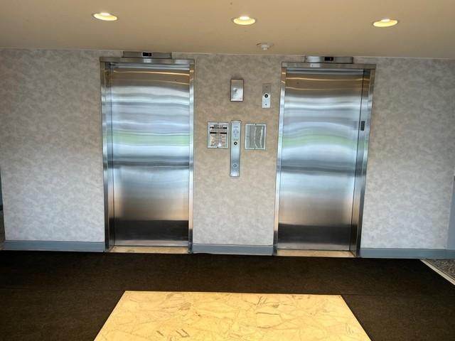 kitchen featuring elevator, recessed lighting, and wallpapered walls