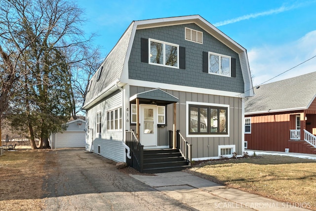 view of front property with an outbuilding, a garage, and a front lawn