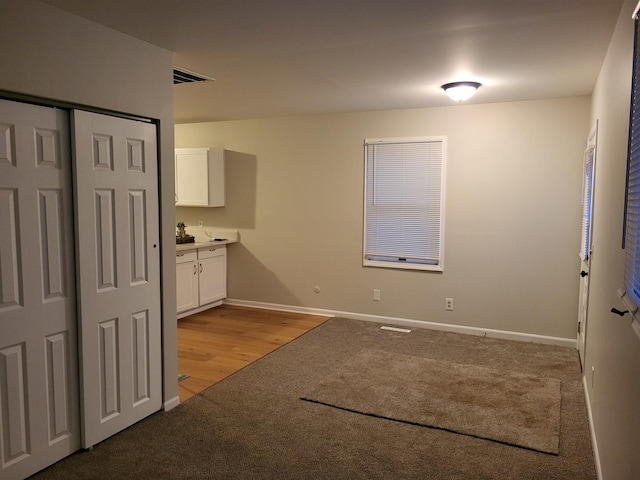 interior space featuring light carpet