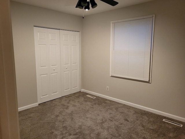 unfurnished bedroom with carpet, ceiling fan, and a closet