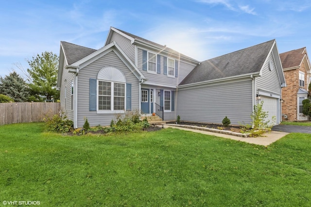 view of front property featuring a garage and a front yard