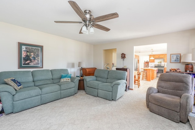 living room with carpet floors and ceiling fan