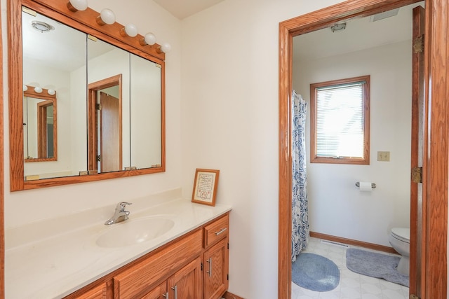 bathroom featuring vanity and toilet