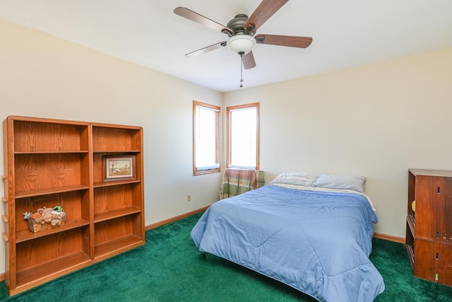 bedroom with ceiling fan and dark colored carpet