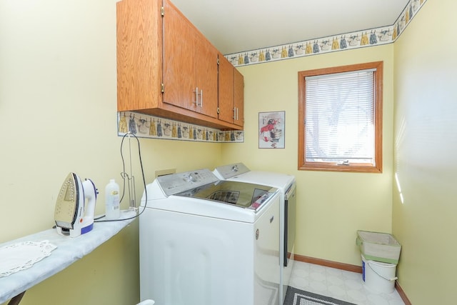 laundry area with cabinets and washing machine and dryer