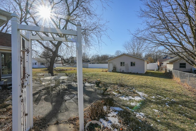 view of yard with an outdoor structure and a patio