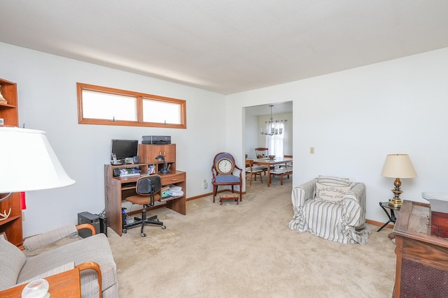 carpeted home office featuring an inviting chandelier and a healthy amount of sunlight