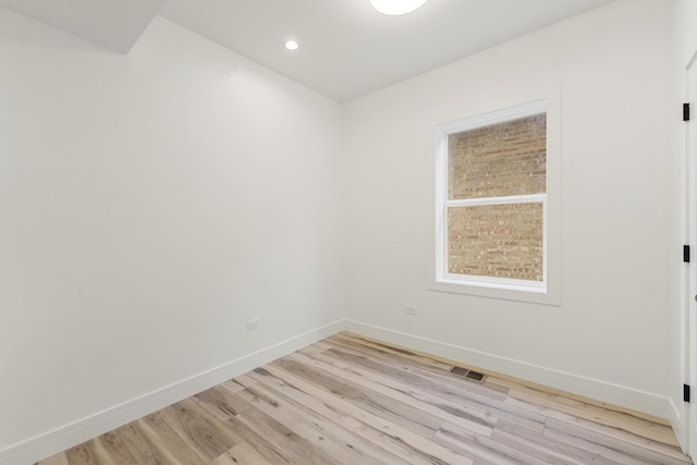 unfurnished room with light wood-type flooring