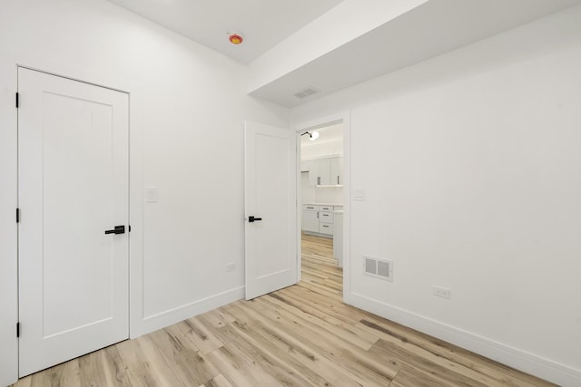 unfurnished bedroom with light wood-type flooring