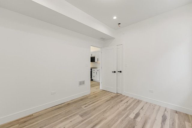 unfurnished room featuring light wood-type flooring