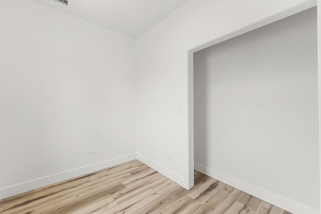 spare room featuring light wood-type flooring