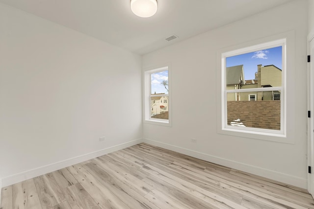 spare room with light hardwood / wood-style flooring