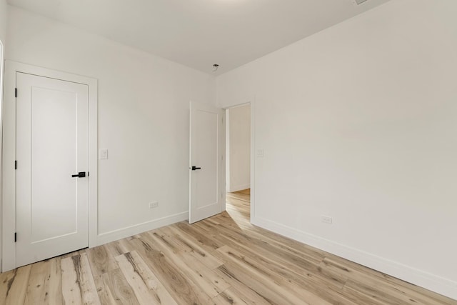 unfurnished room with light hardwood / wood-style floors