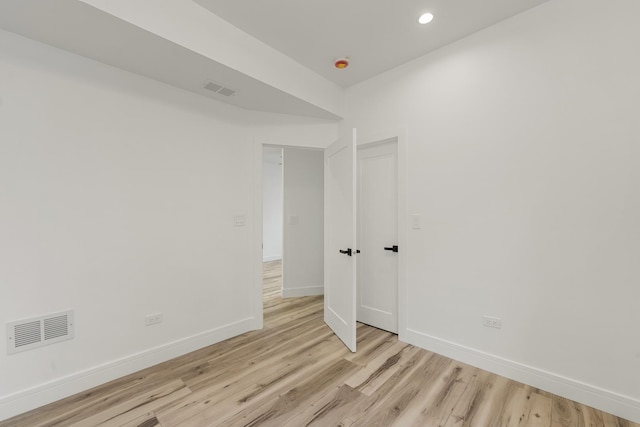 spare room featuring light hardwood / wood-style flooring