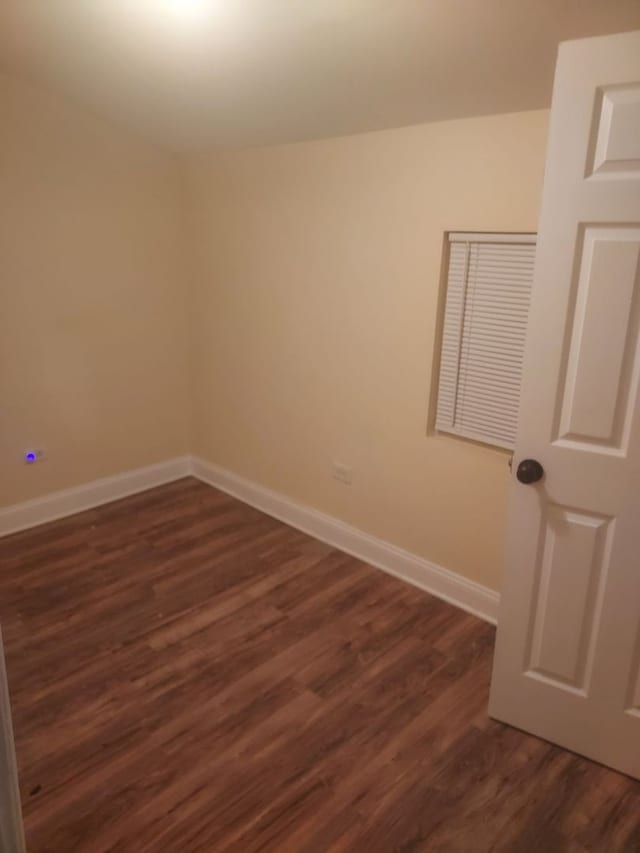 spare room featuring dark hardwood / wood-style flooring