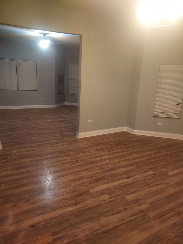 unfurnished room with dark wood-type flooring