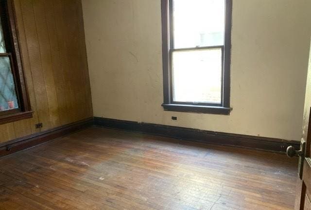 unfurnished room featuring dark hardwood / wood-style flooring