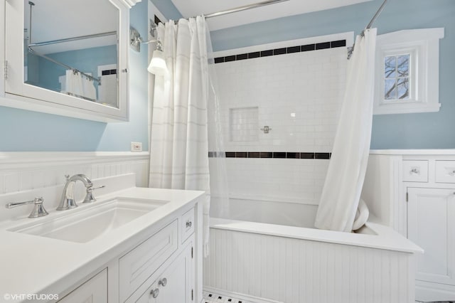 bathroom featuring shower / tub combo and vanity