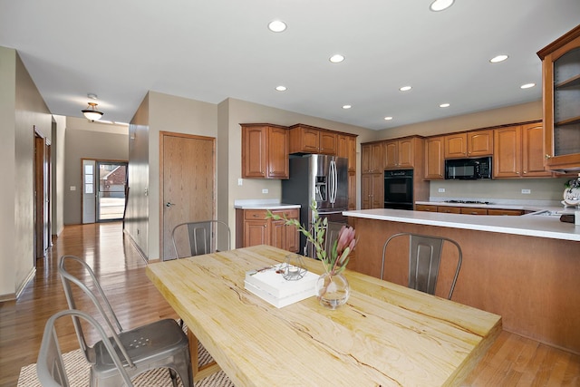 kitchen featuring light hardwood / wood-style flooring and black appliances