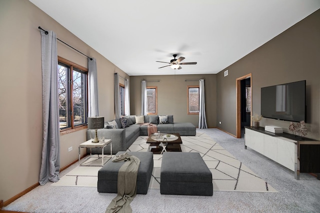 carpeted living room featuring ceiling fan