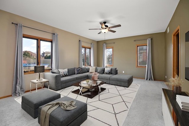 living room featuring light colored carpet and ceiling fan