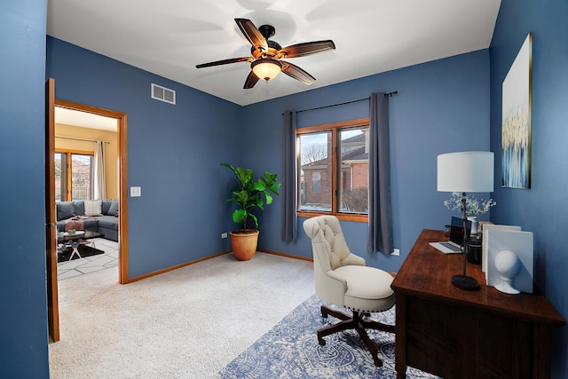 office area with a healthy amount of sunlight, light colored carpet, and ceiling fan