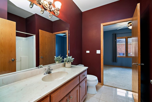 bathroom with a shower, tile patterned flooring, vanity, ceiling fan, and toilet