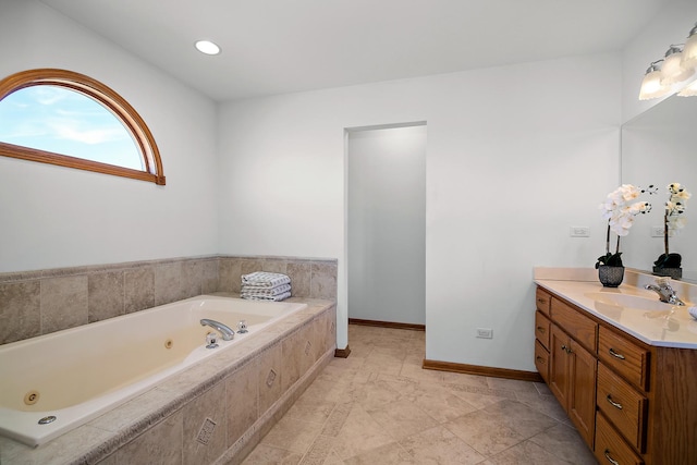 bathroom with vanity and tiled bath