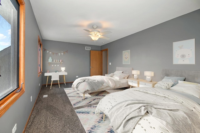 bedroom with ceiling fan and dark carpet