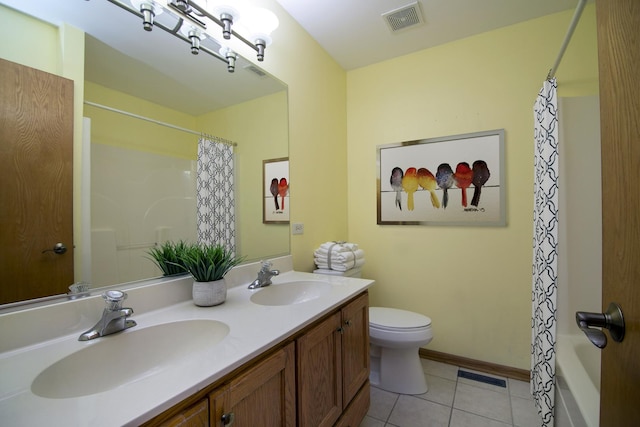 bathroom featuring tile patterned flooring, vanity, and toilet