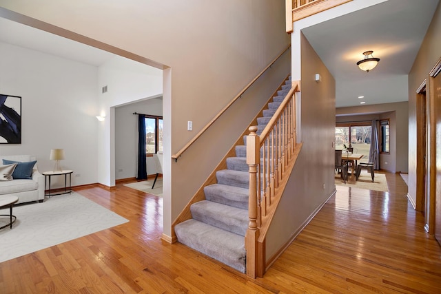 stairway with hardwood / wood-style floors