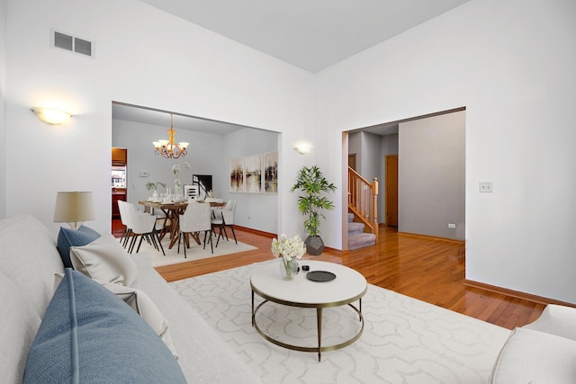 living room with hardwood / wood-style floors and a chandelier