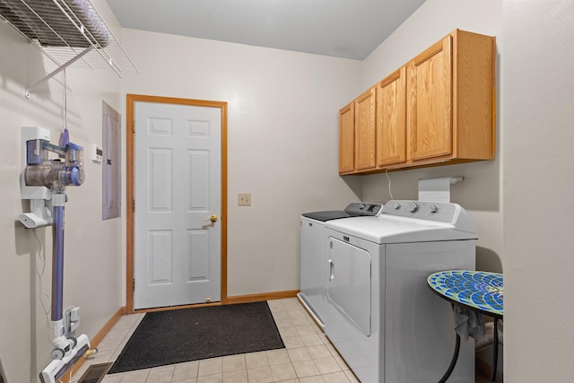 laundry room with cabinets, washing machine and clothes dryer, electric panel, and light tile patterned floors