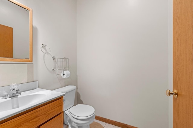 bathroom with tile patterned floors, vanity, and toilet